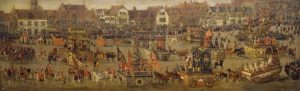 Medieval village with people, tents, horses, and other period activites.